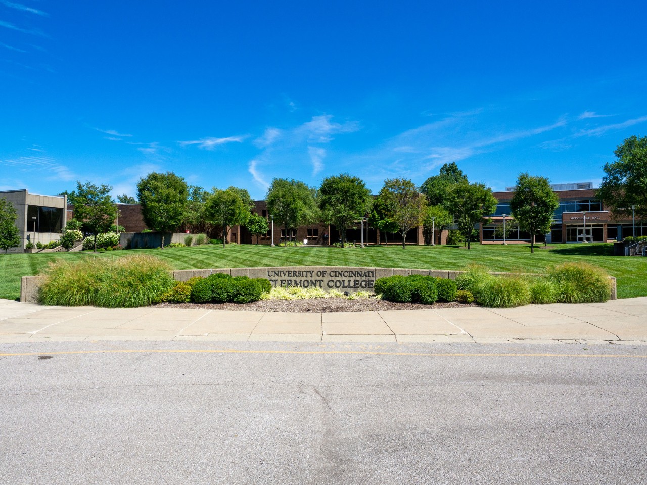 The University of Cincinnati Clermont welcome sign under a bright blue sky