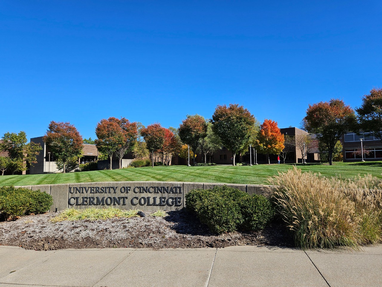 The University of Cincinnati Clermont welcome sign under a bright blue sky